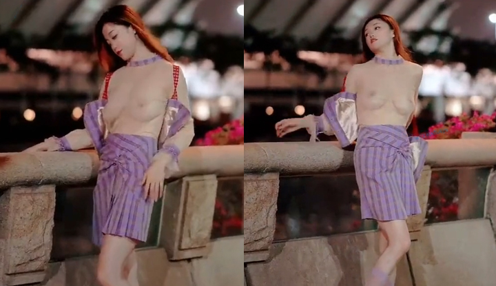 A goddess with a striking contrast, revealing her sexy and beautiful large breasts in sheer fabric by the river.