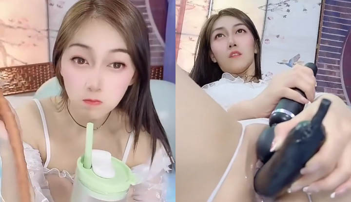 Qingqing, a promiscuous woman, vigorously masturbates with a large dildo, using both hands.